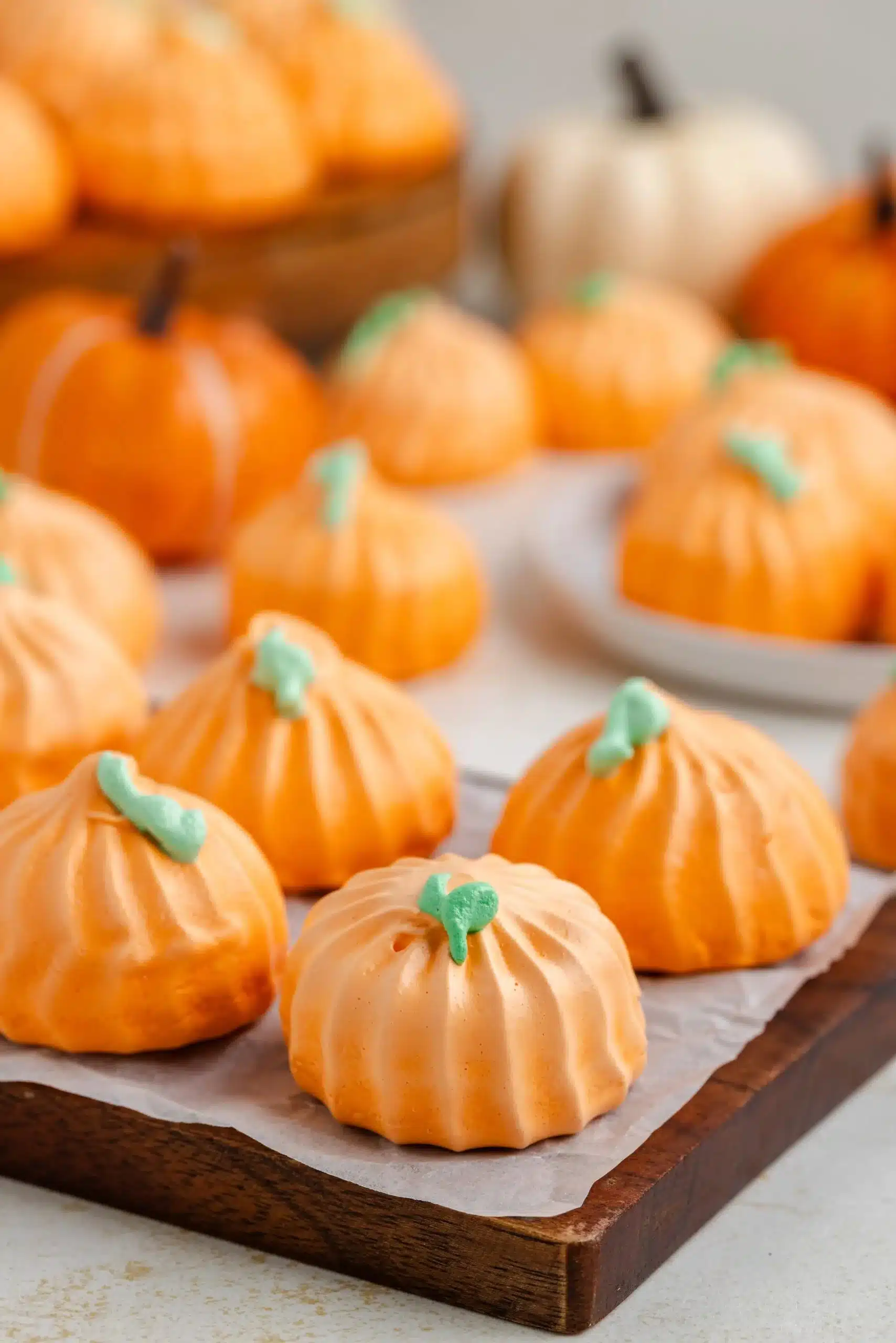 Pumpkin Meringue Cookies displayed on a rustic wooden table