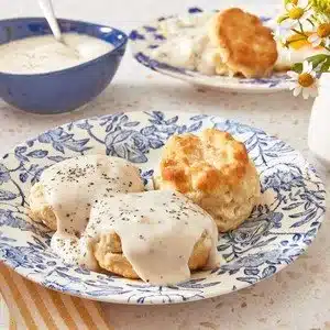 Homemade country gravy served over biscuits for a delicious breakfast.