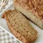 Freshly baked easy sourdough zucchini bread on a wooden table