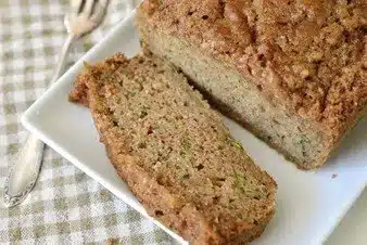 Freshly baked easy sourdough zucchini bread on a wooden table