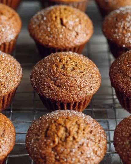 Delicious freshly baked gingerbread muffins topped with spices and sugar.