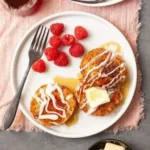 Delicious French Toast Cinnamon Roll topped with syrup and cinnamon.