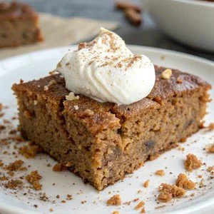 Flourless gingerbread Greek yogurt cake slice topped with spices and frosting