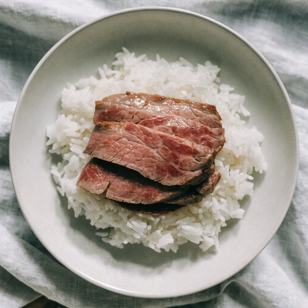Thin sliced beef served over white rice with mild seasoning, simple and kid-friendly meal for picky eaters