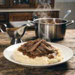 Thin sliced beef with brown gravy served over creamy mashed potatoes, comfort food dish