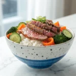 Easy Thin Sliced Beef and Rice Bowl Recipes white rice, broccoli, carrots, cucumber, sesame seeds, and green onions