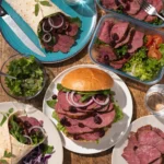 Thin sliced beef sandwiches and wraps with fresh vegetables arranged for quick and easy lunch meal prep